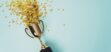 A golden trophy cup with golden stars spilling out of it on a blue background.